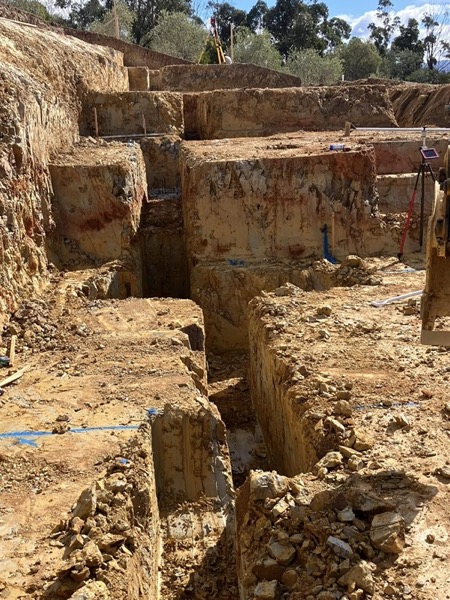 A deep, cleanly cut excavation trench